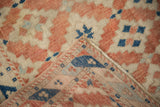 Distressed Dosemealti rug showing terracotta, ivory, and blue diamond guls with woven foundation.