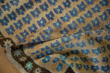 Vintage Oushak rug with royal blue and mint floral blossoms, showcasing textural pile and abrashes.