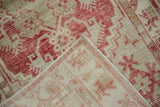 Corner detail showing the hand-knotted construction and woven foundation of a distressed Oushak rug.