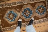 Distressed Vintage Kars runner with primitive sapphire blue geometric medallions and soft, even wear.