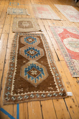Distressed hand-knotted Kars rug with sapphire blue geometric and gul floral motifs.
