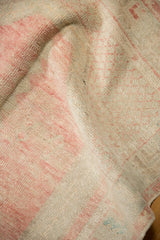Detail of the mostly even wear across the hand-knotted pile on a vintage Oushak rug.
