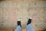 Distressed texture and scale of a vintage Oushak runner in dusty rose and muted gold tones.