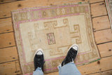 Distressed Kars square rug showcasing geometric medallion, faded magenta, ivory, and green tones.