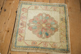 Distressed Oushak rug mat with a scalloped medallion in a soft, muted color palette.