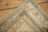 Corner detail of a vintage Oushak rug with floral and zig-zag borders and secured selvage.