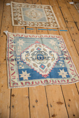 Corner view of distressed Oushak rug, showing fringe, abrash texture, dusty blue and red.