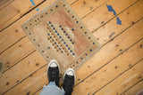 Distressed texture and dusty cobalt blue border motifs on a vintage Oushak rug corner.