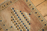 Distressed vintage Oushak rug pile, showing a diamond pattern in dusty blue and mint within a soft mauve field.