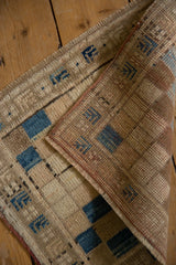 Vintage distressed Oushak rug's tightly woven reverse, visible blue squares, and intact selvage.
