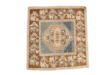 Distressed vintage Oushak square rug with dusty blue medallion and earthy plant border.