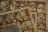 Distressed Oushak rug fold with worn pile, dusty blue, brown, beige geometric motifs, side selvage.