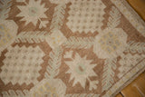 Distressed Oushak rug detail, showcasing textured coffee brown and ivory stepped motifs.