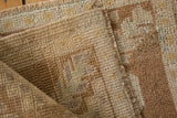 Hand-knotted vintage Oushak rug pile, even wear revealing subtle beige and coffee brown patterns.