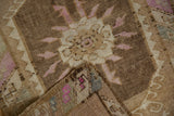 A folded corner reveals the hand-knotted construction and distressed texture of this vintage Kars rug.
