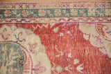 Distressed Oushak runner: cherry red field wear, ivory, dusty teal, and violet border patterns.