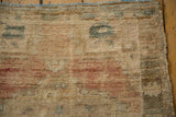 Distressed vintage Oushak rug pile, showing abrash with dusty gold, sand, and raspberry hues.
