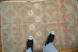 Distressed vintage Oushak rug featuring pale mint and terracotta motifs on an abrashed ground.