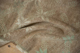 Tightly hand-knotted texture on the reverse of a vintage Oushak rug with subtle pale green motifs.