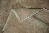 Woven foundation of a vintage Distressed Oushak rug, showing its secured edges and worn pile.