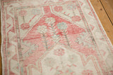Distressed Oushak runner with visible foundation, pink, ivory, and faded turquoise geometric border.
