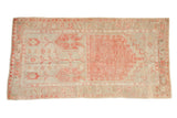 Vintage distressed Oushak rug runner with a geometric prayer design in faded red and sand.