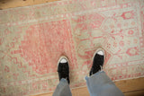 A perspective view showing the softly worn texture of a vintage distressed Oushak rug runner.