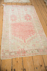 Distressed Oushak runner with faded cherry red and sand tones in a prayer rug design.