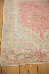 Intact side cord selvage and low, even pile on a distressed vintage Oushak rug corner.