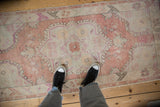 Vintage distressed Oushak runner in dusty rose, showing its lived-in texture underfoot.