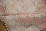 Soft, time-worn texture of a vintage Oushak rug runner in dusty rose, magenta, and ivory.