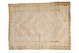 Vintage distressed Tulu square rug with concentric patterns in ivory and orange, and a brown zig-zag border.