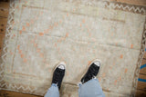 A personal view looking down at the soft texture and distressed pile of a vintage Tulu rug.