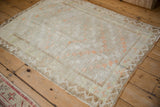 High-angle view of a distressed Tulu rug, showing its shaggy texture and time-softened pile.