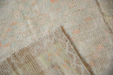 A vintage Tulu rug's corner revealing the textured pile against its flat woven back.
