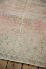 Distressed low-pile texture showing the visible knot heads on a vintage hand-knotted Oushak rug.