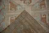 Hand knotted vintage Oushak runner with distressed pile, geometric design, and visible woven foundation.