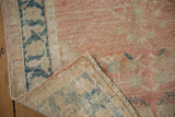 Distressed Oushak runner's hand-knotted structure, low pile, faint foundation, and side selvage.