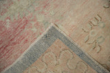 Folded corner reveals the hand-knotted back and distressed pile of a vintage Oushak runner.