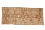 Distressed vintage Turkish Kars runner featuring geometric starbursts in coffee brown, beige, and soft terracotta.