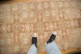 Downward view of the even wear and geometric starburst pattern on a vintage Kars runner.