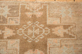 Geometric hook and latch relief details showing the low, even pile of a distressed Kars rug.