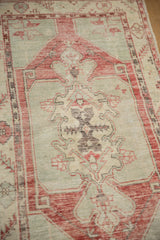Distressed Oushak runner medallion with triple finial contour, showing wear to foundation.