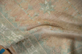Textural close-up of a vintage Oushak rug's pile, with even wear to the knot heads.