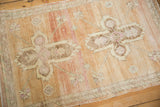 Distressed vintage Oushak rug detail, showing abrashed sandalwood, pale magenta blossoms, and wear.