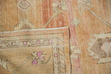 Folded corner reveals distressed pile, abrash, woven foundation, and geometric minor border.