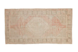 Vintage distressed Oushak runner, faded blush hexagonal medallion, ivory ground, soft, worn texture.