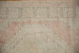 Low pile vintage Oushak rug texture with faded blush, ivory, and silver abrash.