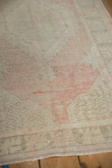 Distressed pile texture of vintage Oushak rug in faded blush, ivory, and silver.