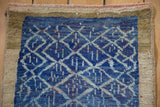 Distressed vintage Oushak rug detail showing cobalt blue lattice and wide natural border.